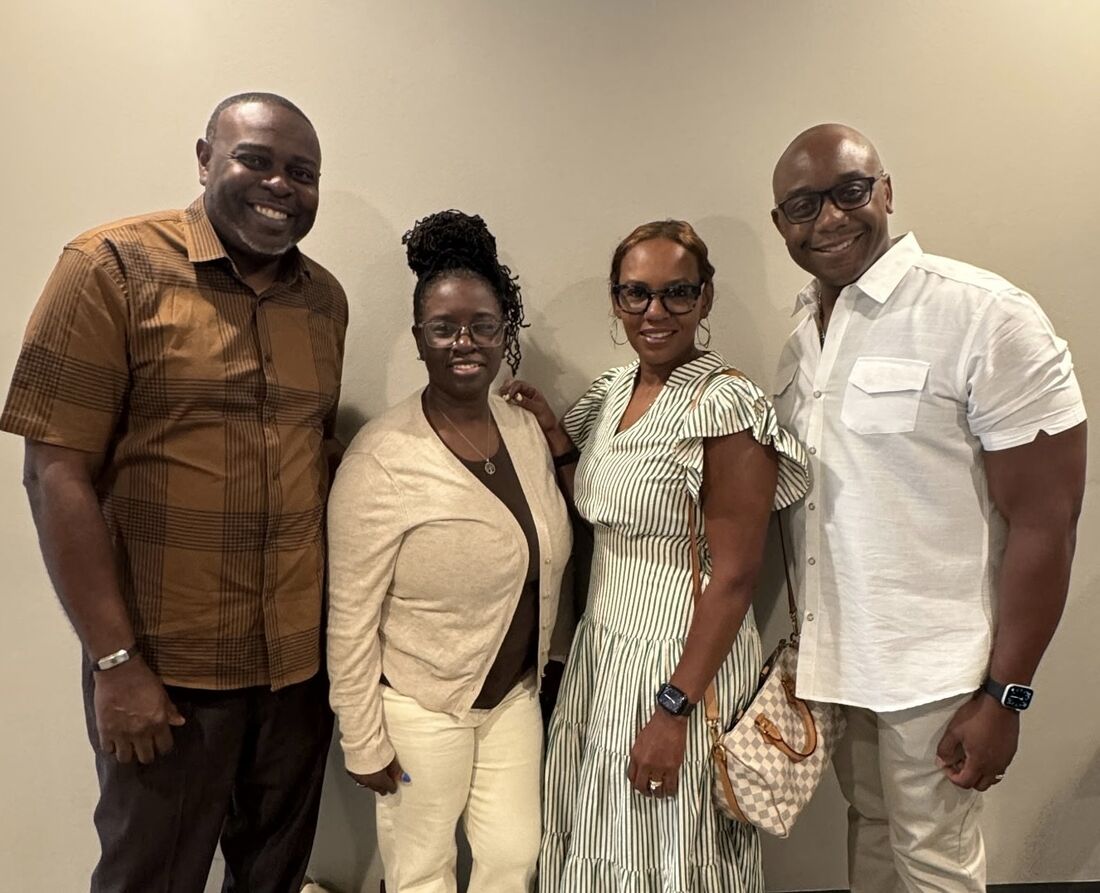 Members of the board standing together and smiling
