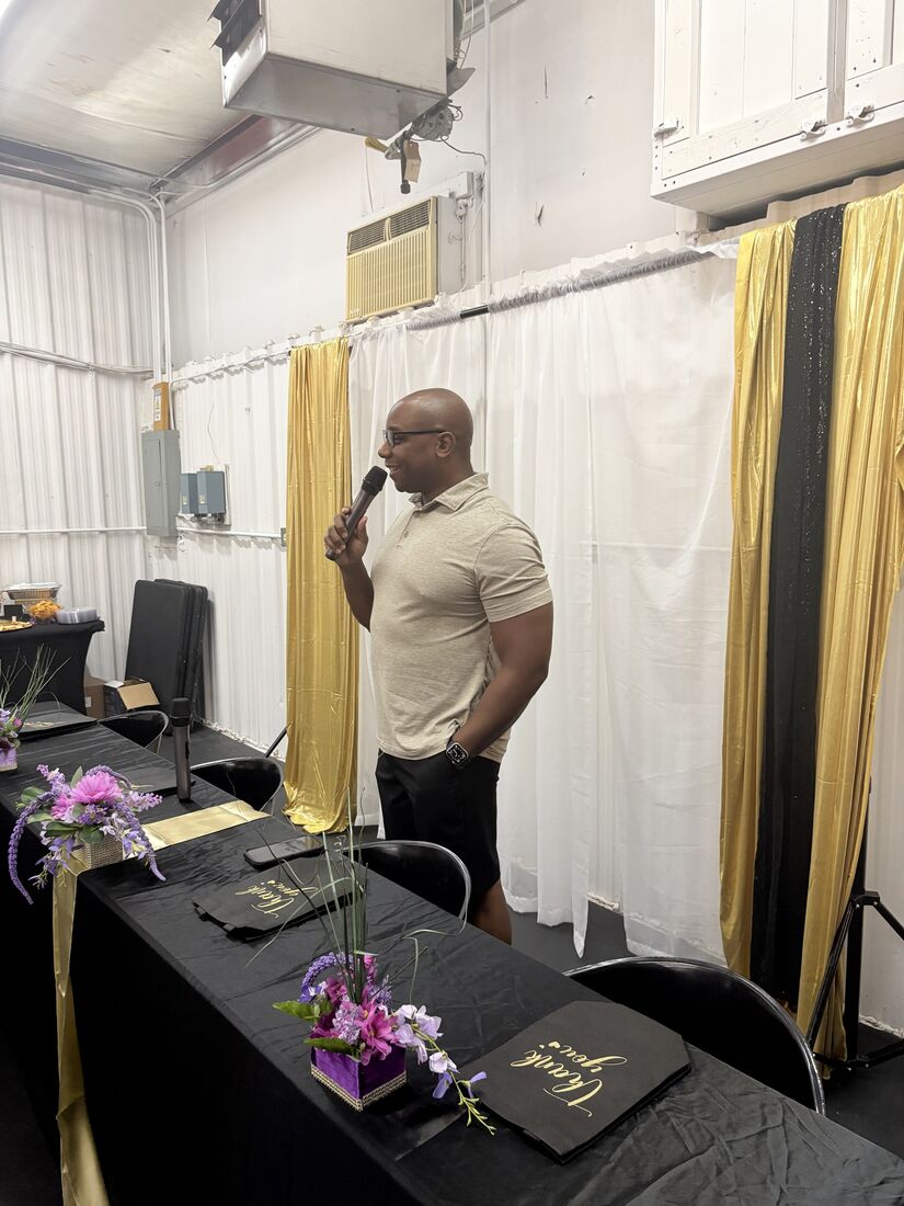 A guest speaker in a beige polo shirt speaking at the launch event
